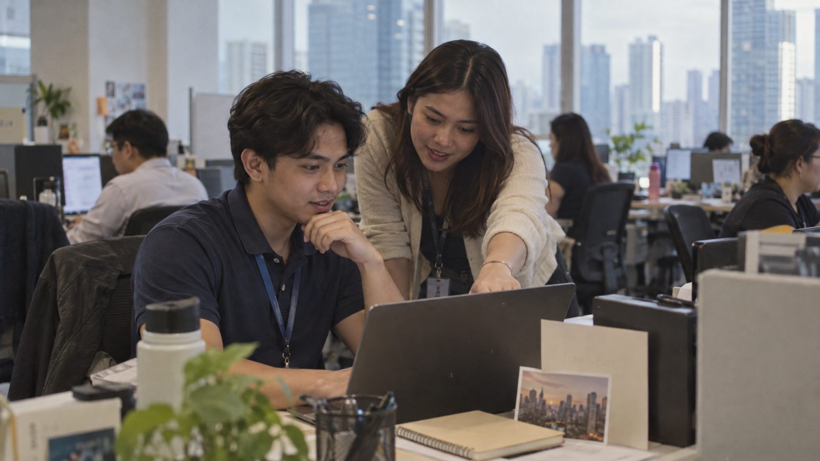 A colleague helping a new hire on his first morning